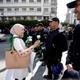 A demonstrator offers a flower to a police officer as teachers and students take part in a protest demanding immediate political change in Algiers, Algeria March 13, 2019.